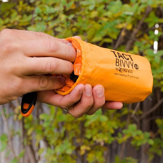 Survival Frog Tact Bivvy 2.0 Emergency Sleeping Bag w/Stuff Sack, Carabiner, Survival Whistle, ParaTinder - Compact, Lightweight, Waterproof, Reusable, Thermal Bivy Sack Cover, Shelter Kit